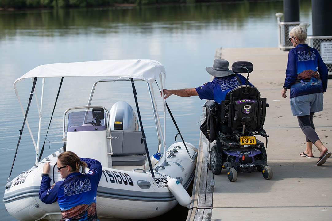 Man in wheelchair getting on boat