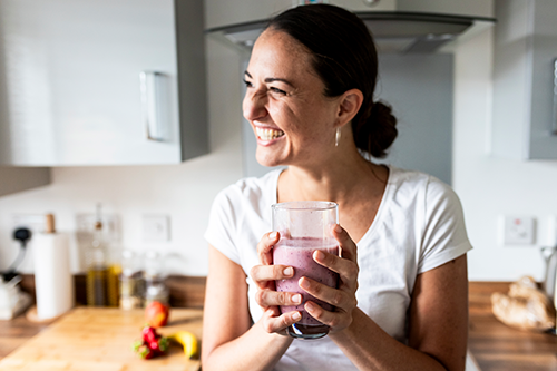 Smiling woman with smoothie