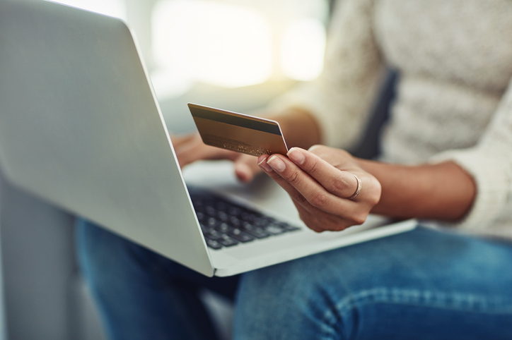 Woman using credit card to shop online