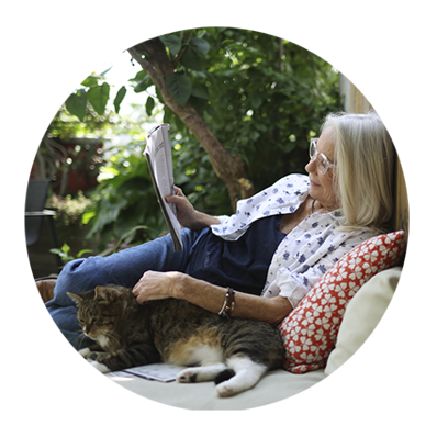woman reading and stroking cat