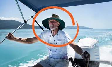 Older man driving boat