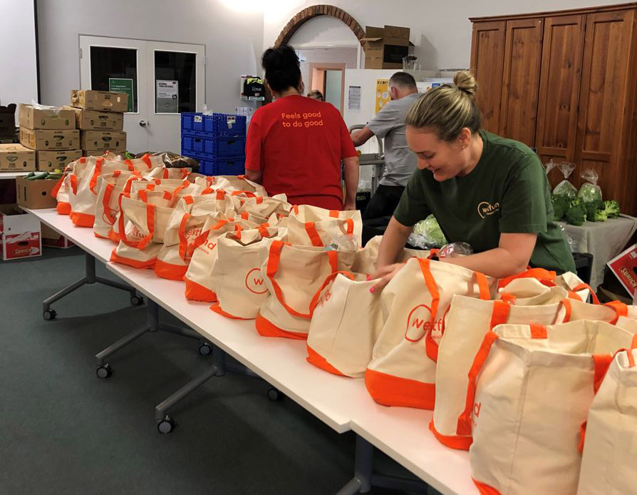 Westfund staff packing hampers with fresh produce for Christmas 2021 at the Lithgow Information and Neighbourhood Centre.
