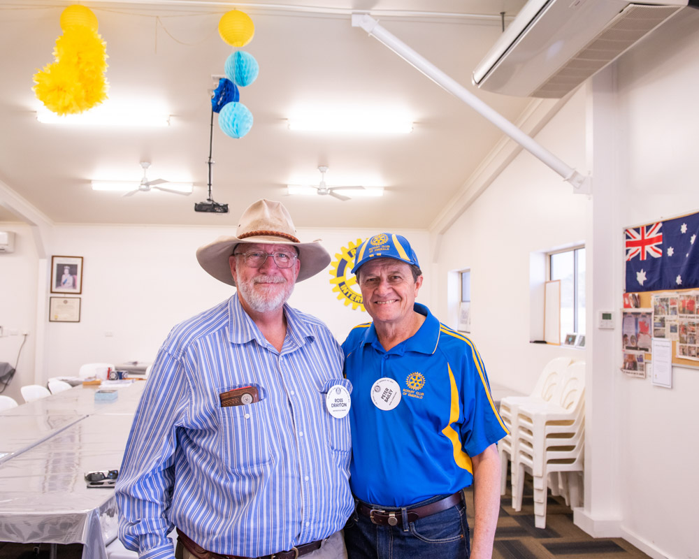 Two men in Rotary clubhouse smiling