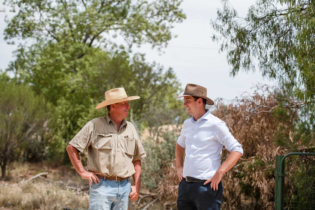 two Australian men chatting on farm