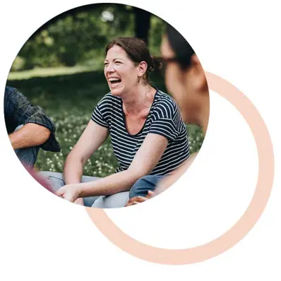 woman in park with friends smiling