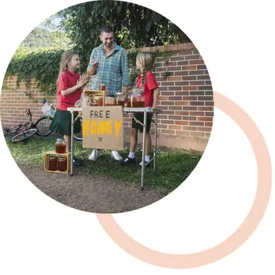 man and daughters giving away honey outside of home
