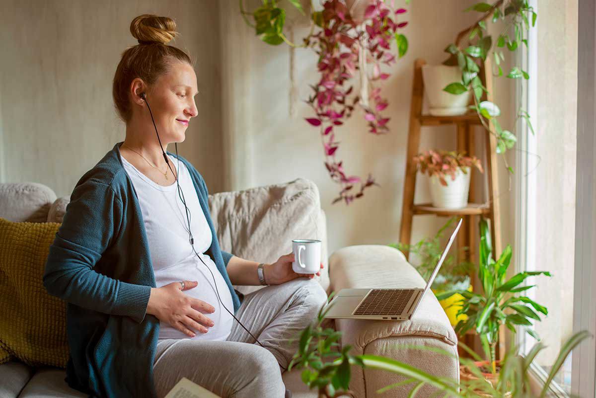 Pregnant woman looking at computer