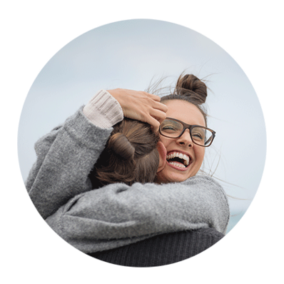 woman on beach hugging person