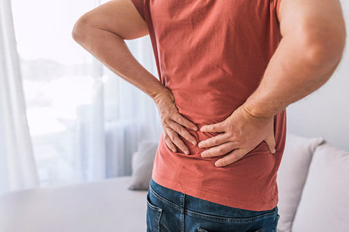 Man with sore back - physio vs chiro