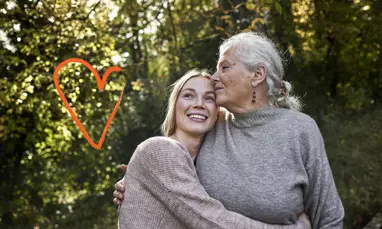 older woman being hugged by younger woman