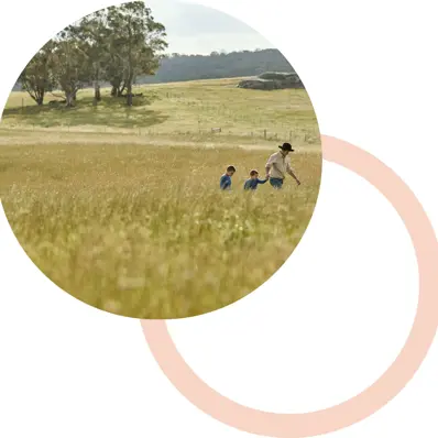 Farmer father and two kids in a field