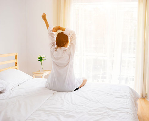 Woman getting out of bed