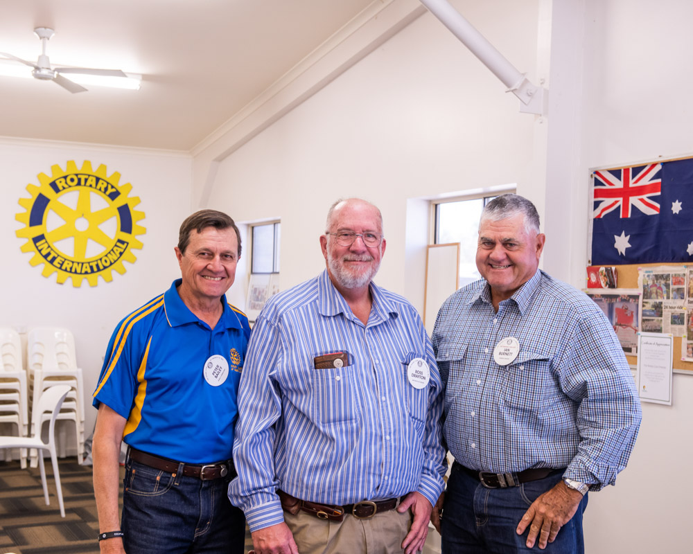 Three male Rotarians smiling to camera
